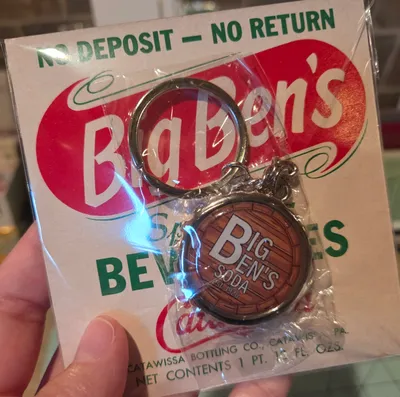 Bottle Cap-shaped Bottle Opener Keychain - My Family owns a very small soda company in Pennsylvania and were celebrating our 100th year anniversary These bottle cap keychains were a limited item we got to help celebrate this massive milestone The backing is one of our old labels from the 1960s