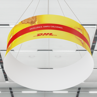 A curved overhead banner with the DHL logo and the slogan 'EXCELLENCE. SIMPLY DELIVERED.' against a yellow and red background, likely displayed in an indoor commercial space.